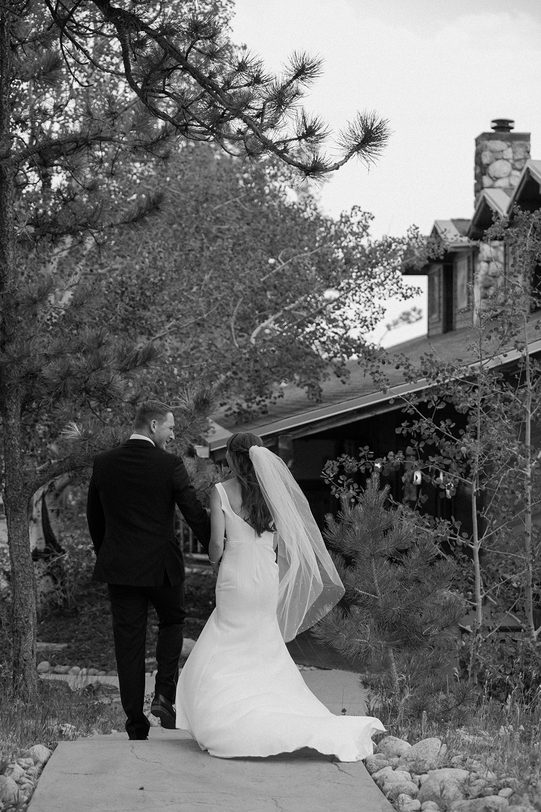 Jason and Amy kissing on the rocks framed by aspen trees